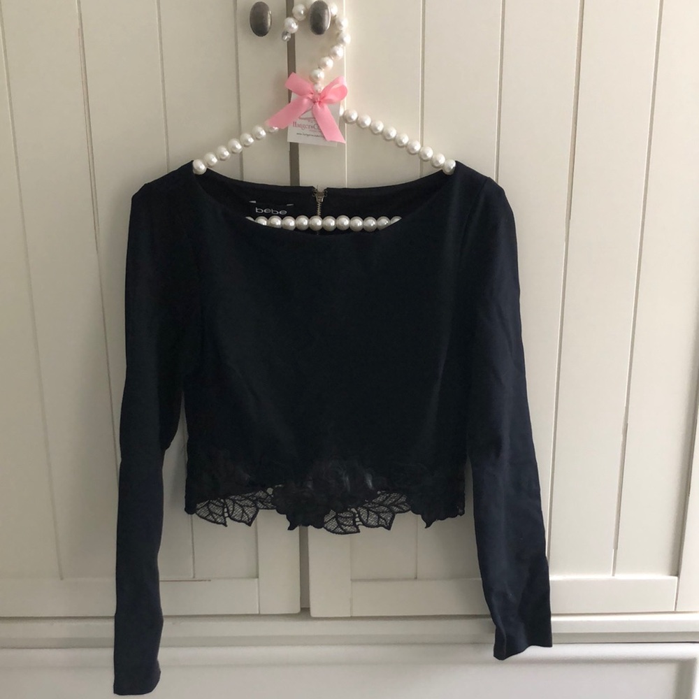 Bebe black long sleeve top with beautiful floral appliqué at hemline. XS